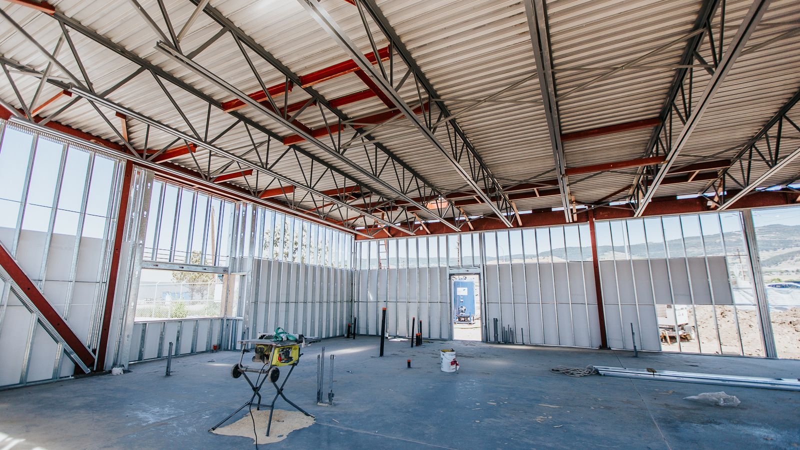 A large room with steel framing installed by Kelco Drywall Ltd, where safety is the top priority