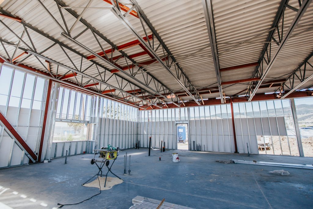 An example of Kelco Drywall's steel stud framing work, in a large room with steel frames and concrete floors.