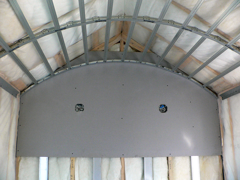 A room with metal frames midway through a specialty framing installation by Kelco Drywall in a curved-ceiling room.