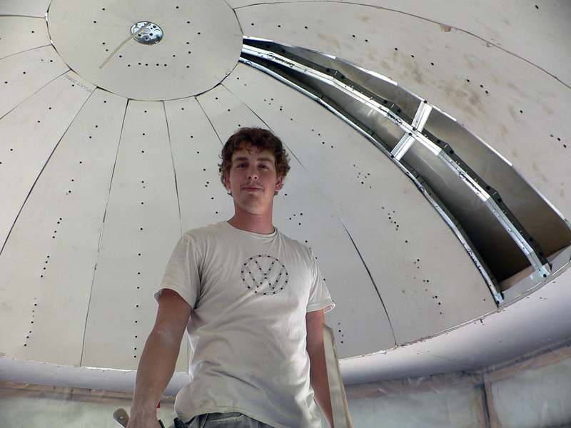 One of Kelco Drywall's crew members installing specialty framing to a curved, domed roof room.