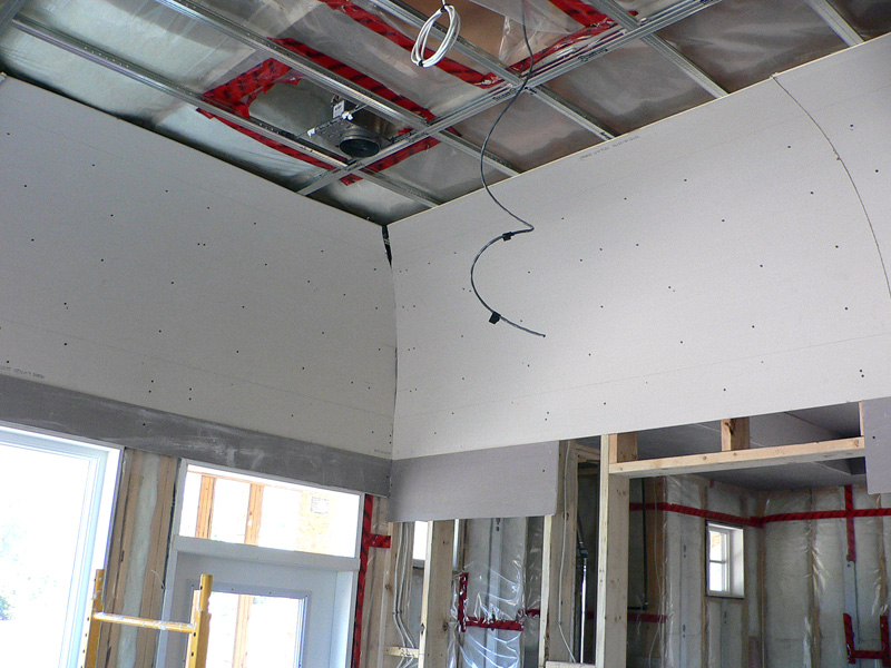 An example of Kelco drywall's specialty framing mid way through installation, which shows metal frames and wooden curved sheets